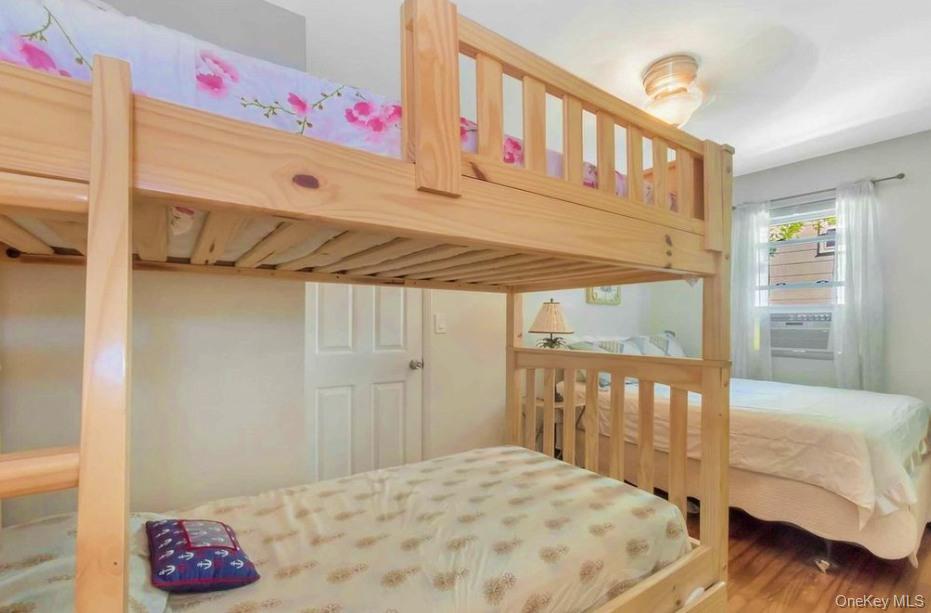 430 Grove Road Southold, NY 11971 - Photo 13 of 15 a bedroom with a bed and a window