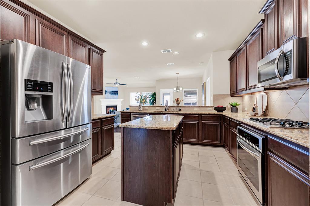 4813 Stacy Court Rowlett, TX 75088 - Photo 6 of 36 Deep, rich-colored cabinets that compliment the granite