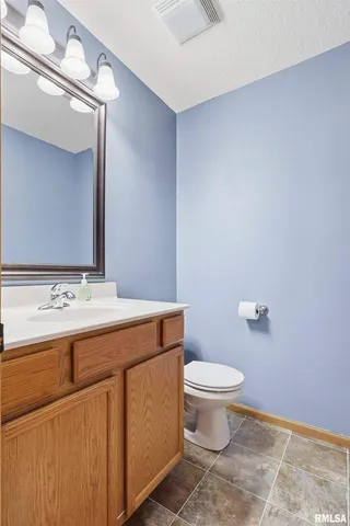 a bathroom with a sink a toilet and mirror