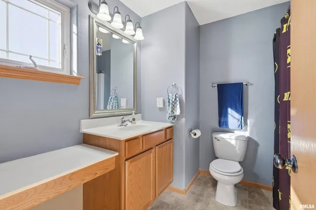 a bathroom with a sink a toilet and mirror