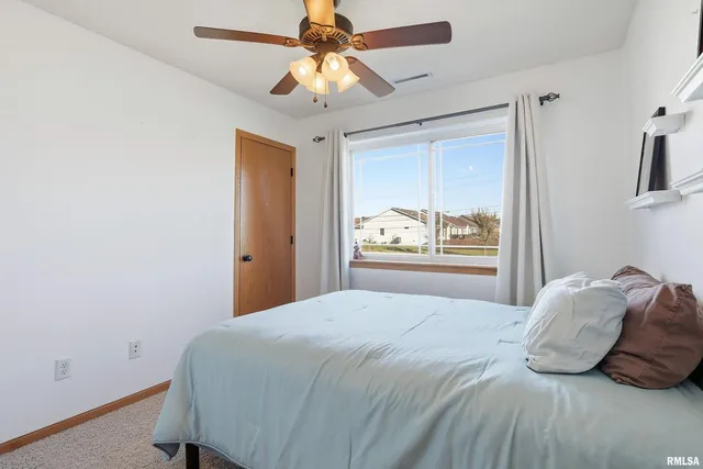 a bedroom with a large bed and a window
