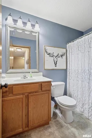 a bathroom with a toilet a sink and a mirror