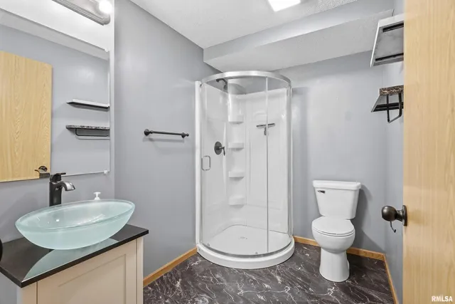 a bathroom with a toilet sink and shower
