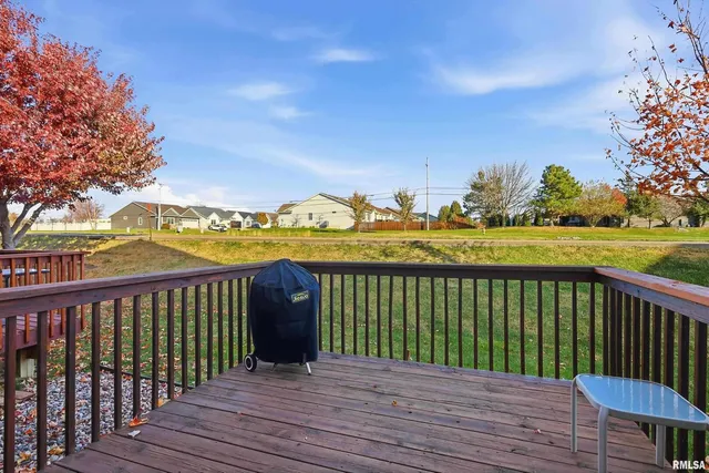 a balcony with wooden floor and city view