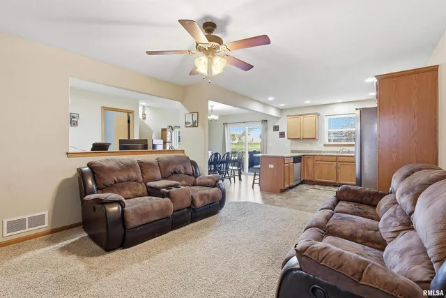 a living room with furniture and kitchen view