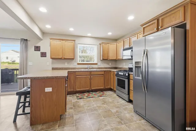 a kitchen with a refrigerator sink and cabinets