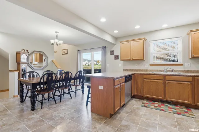 a kitchen with cabinets and wooden floor
