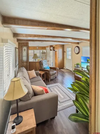a living room with furniture and a bookshelf
