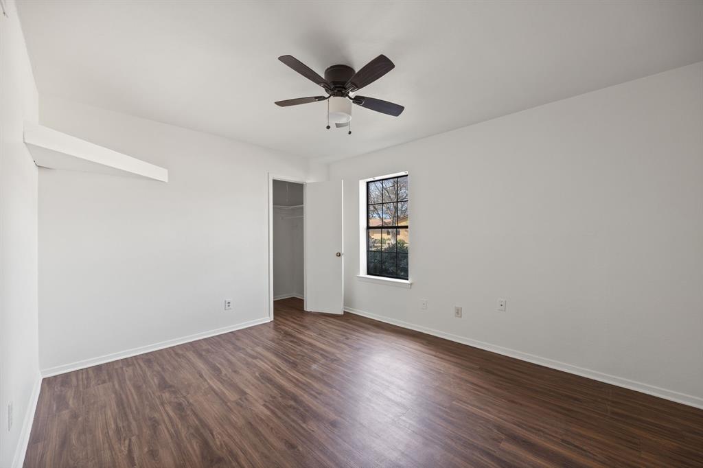2736 Chebi Lane Denton, TX 76209 - Photo 20 of 27 an empty room with wooden floor a ceiling fan and windows