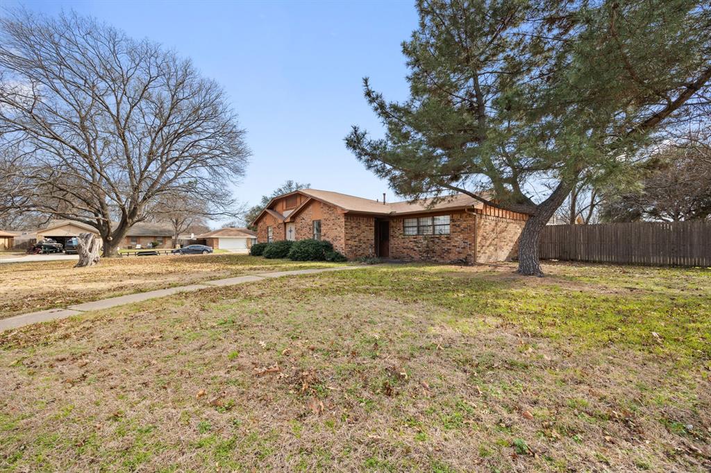 2736 Chebi Lane Denton, TX 76209 - Photo 3 of 27 a front view of house with yard and trees