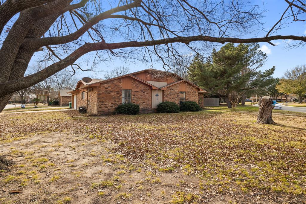 2736 Chebi Lane Denton, TX 76209 - Photo 5 of 27 a yellow house with trees in front of it
