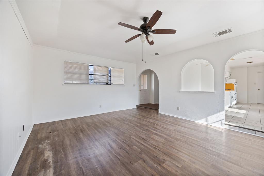 2736 Chebi Lane Denton, TX 76209 - Photo 8 of 27 a view of a livingroom with wooden floor a ceiling fan and windows