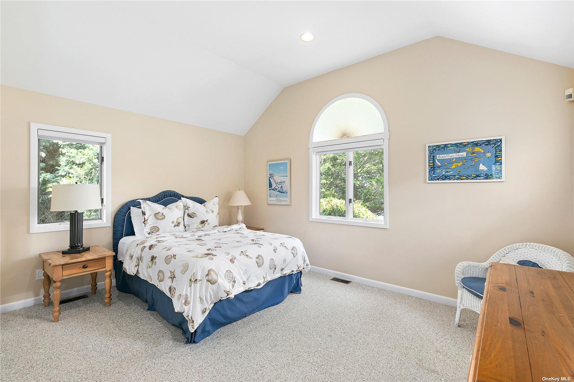 43 Bridle Path Westhampton Beach, NY 11978 - Photo 11 of 15 a bedroom with a bed and a window