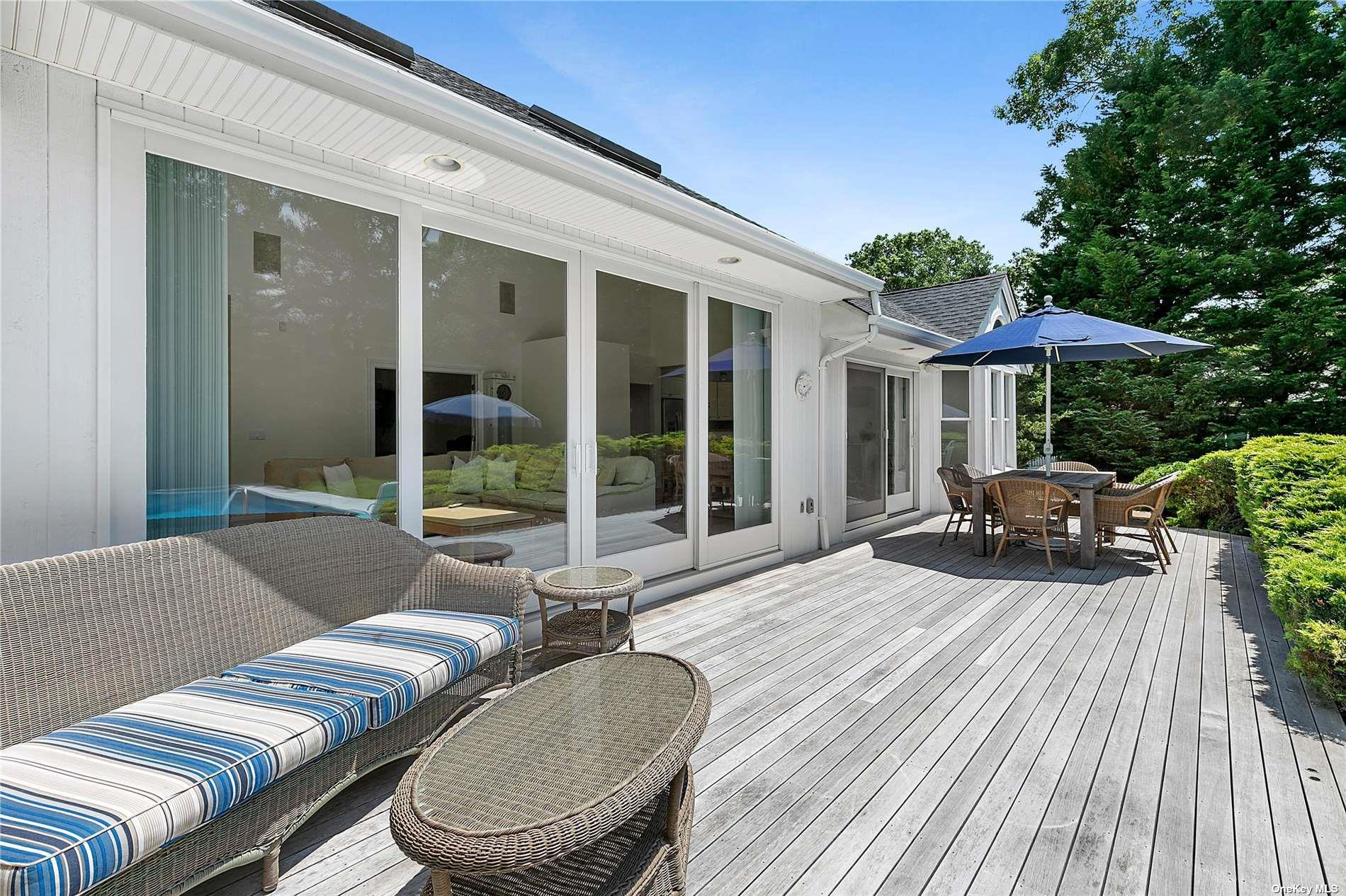 43 Bridle Path Westhampton Beach, NY 11978 - Photo 15 of 15 a balcony with furniture and a garden
