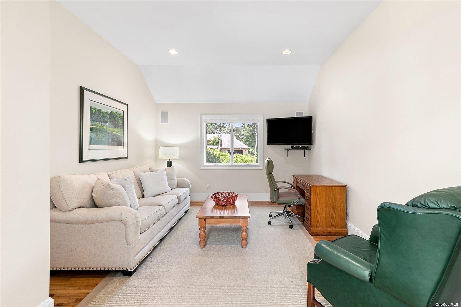 43 Bridle Path Westhampton Beach, NY 11978 - Photo 6 of 15 a living room with furniture and a flat screen tv