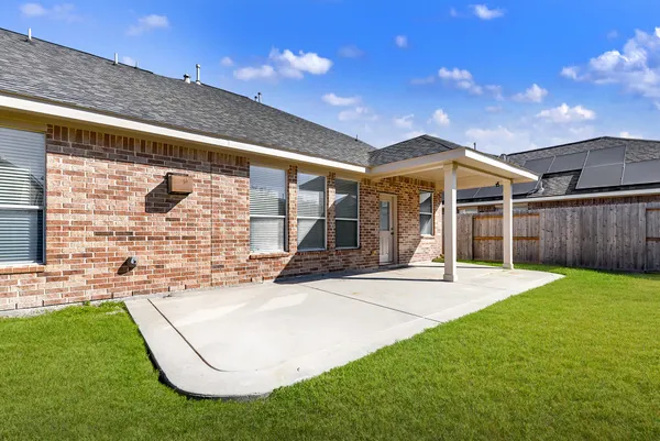 a view of a house with backyard and porch