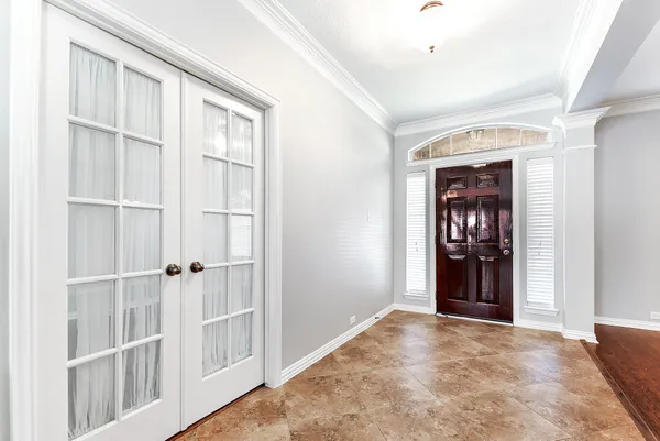 a view of an empty room with cabinet and a window