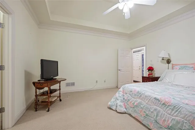 a bedroom with a bed and a computer on the desk