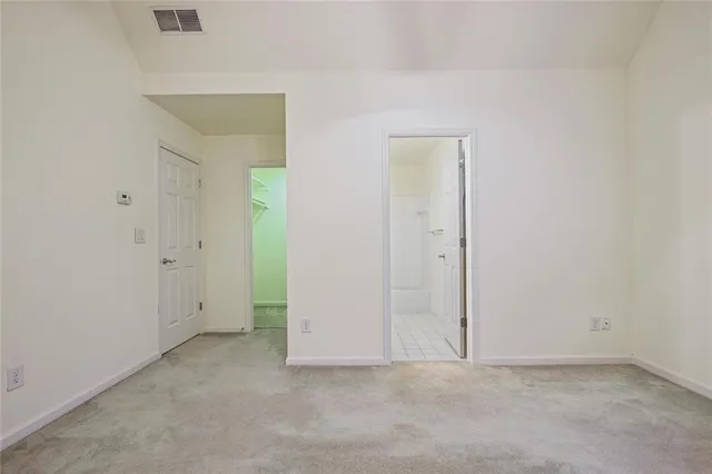 a bathroom with a bathtub shower sink vanity mirror and toilet