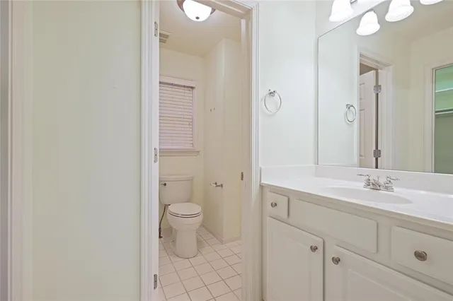 a bathroom with a double vanity sink mirror and toilet