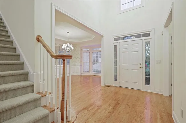 a view of entryway with wooden floor and stairs