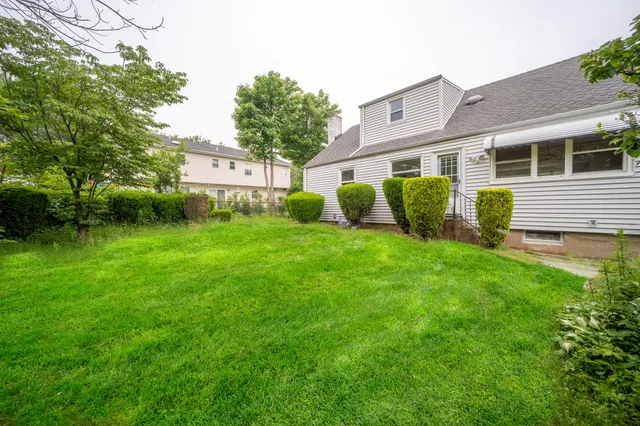 a front view of house with yard and green space