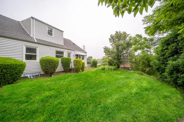 a view of a house with a backyard