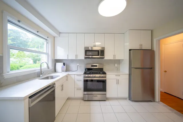 a kitchen with a stove a sink and a refrigerator