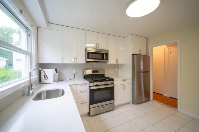 a kitchen with a refrigerator stove and sink