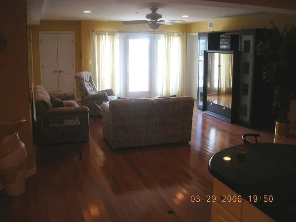 a living room with furniture and a floor to ceiling window