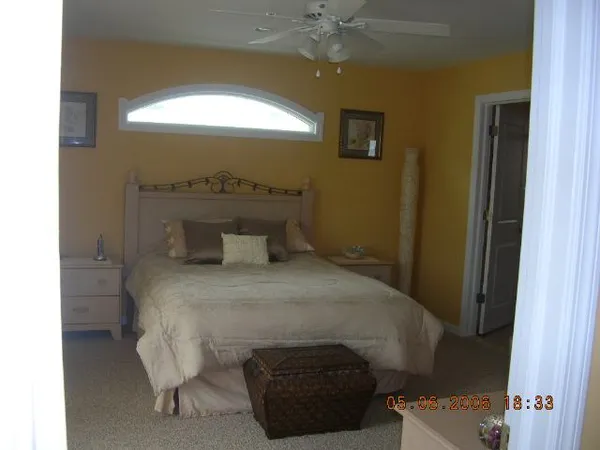 a bedroom with a bed and a window