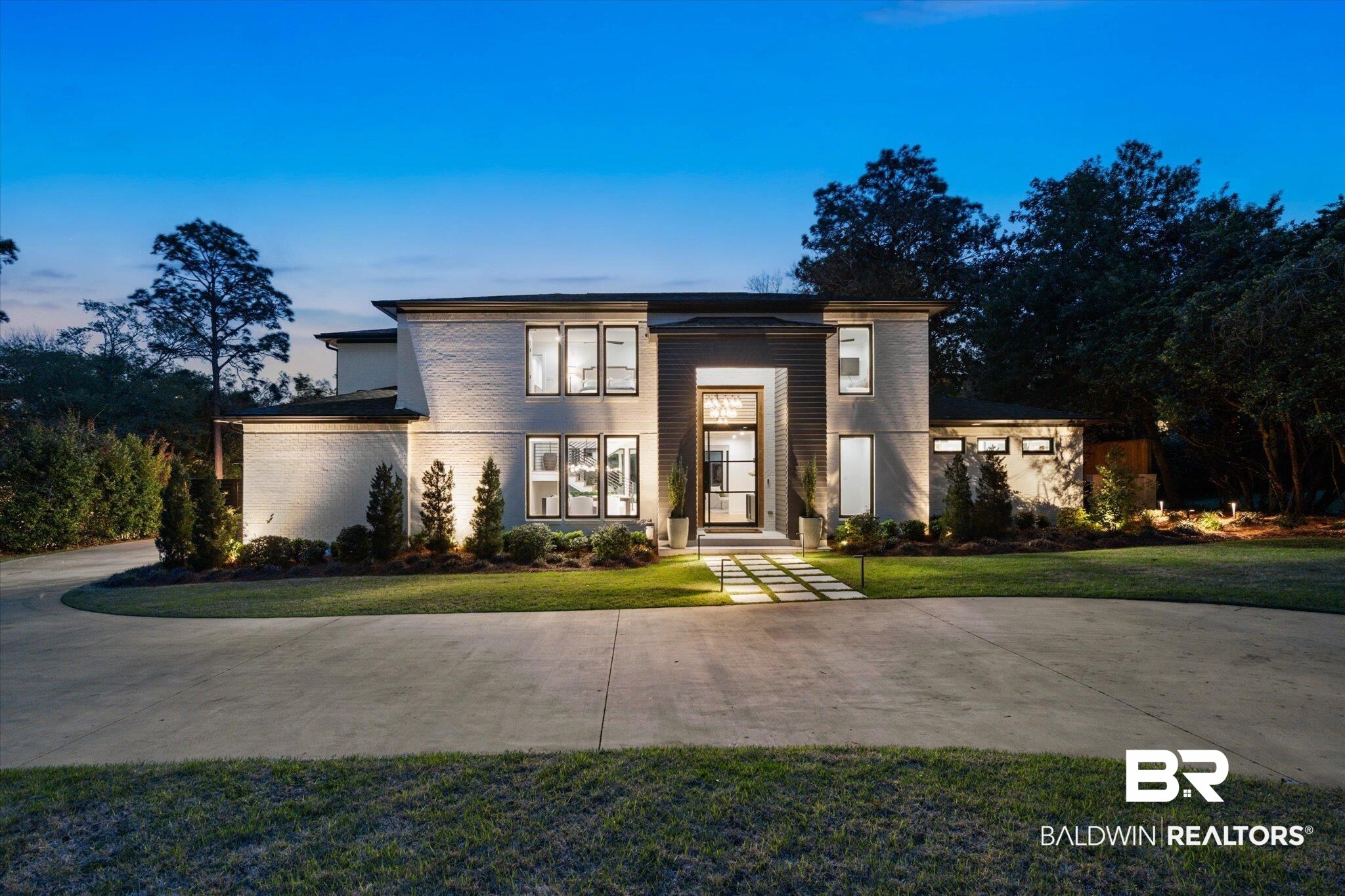 69 Jordan Lane Mobile, AL 36608 - Photo 1 of 57 Contemporary house featuring a front yard, brick siding, and concrete driveway