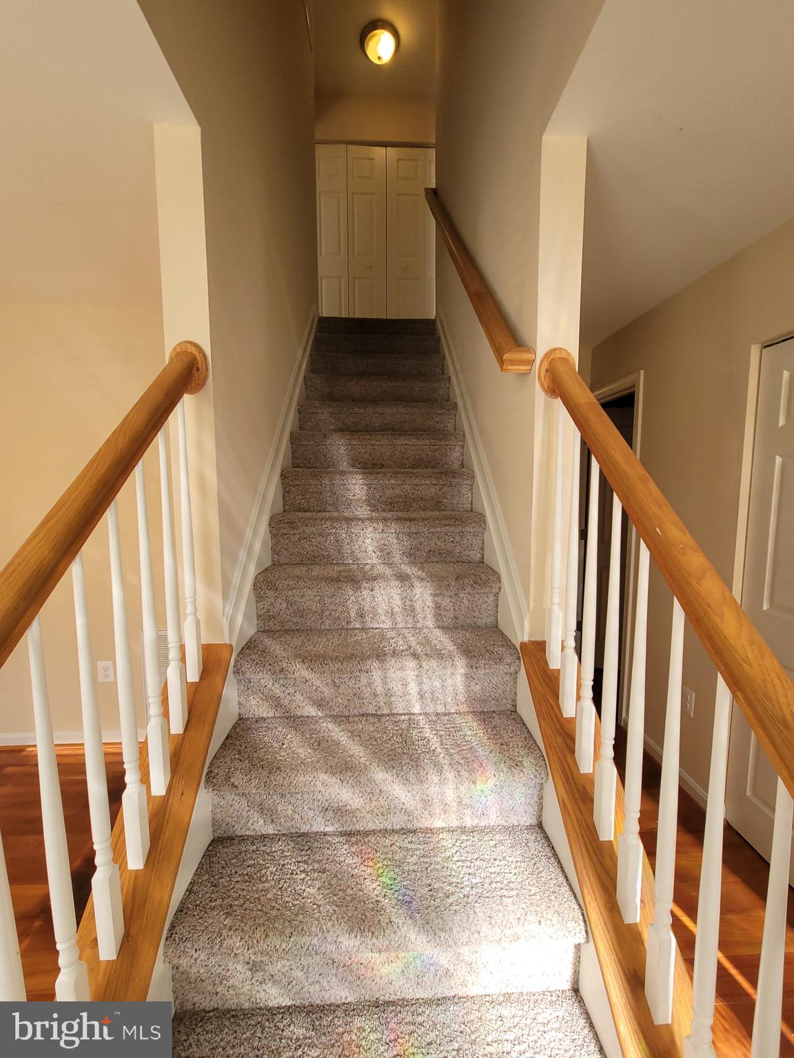 141 Jefferson Road Waldorf, MD 20602 - Photo 17 of 37 a view of staircase with wooden floor and white walls