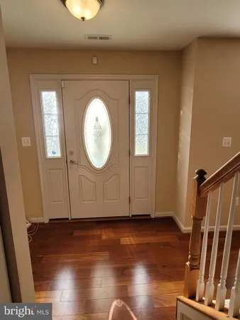 a view of a livingroom with wooden floor and window