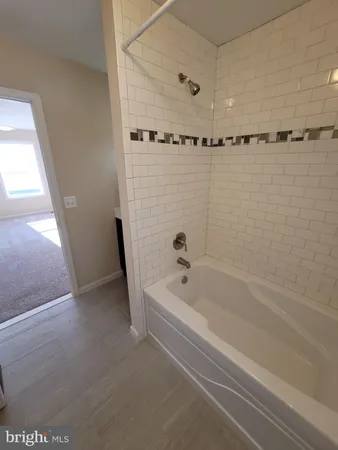 a bathroom with a bathtub and shower