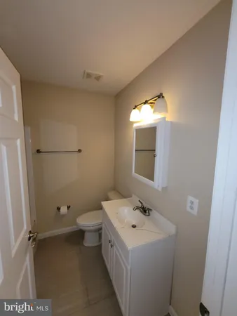 a bathroom with a sink toilet and mirror