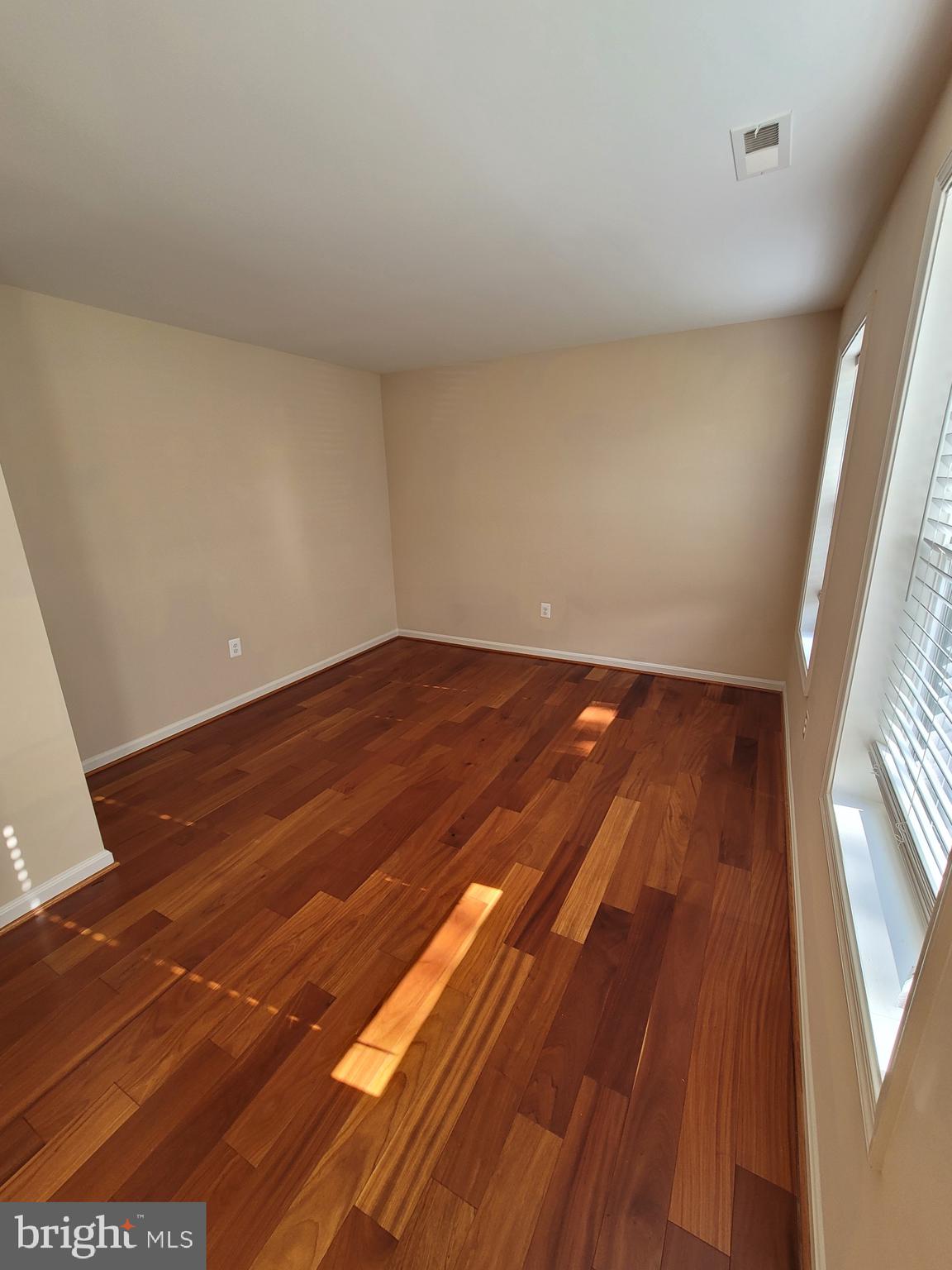 141 Jefferson Road Waldorf, MD 20602 - Photo 3 of 37 a view of an empty room with wooden floor and a window
