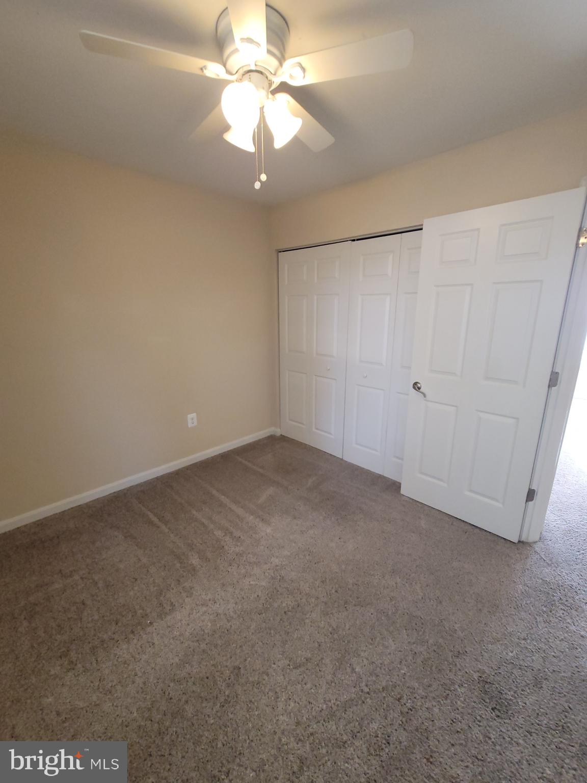 141 Jefferson Road Waldorf, MD 20602 - Photo 31 of 37 an empty room with a chandelier fan and windows