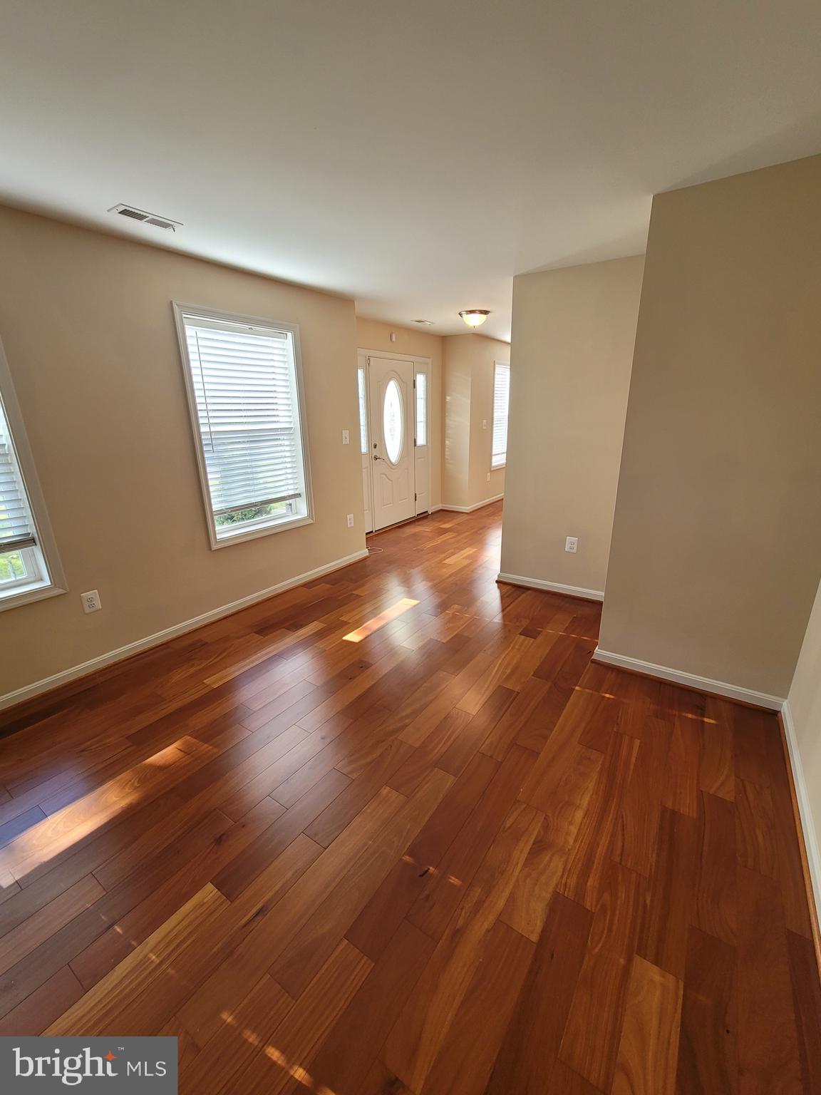 141 Jefferson Road Waldorf, MD 20602 - Photo 4 of 37 an empty room with wooden floor and windows