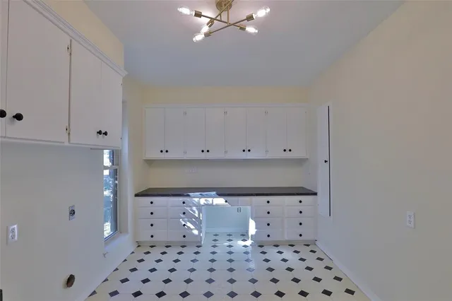 a view of a livingroom with a ceiling fan and window