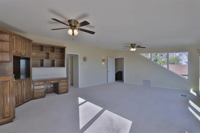 a view of a swimming pool and lounge chairs