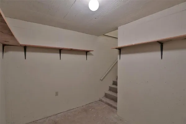 a view of a room with wooden floor and a floor to ceiling window