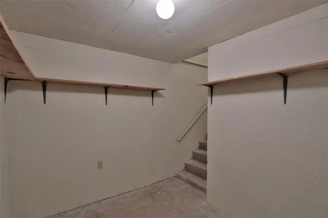 a view of a room with wooden floor and a floor to ceiling window