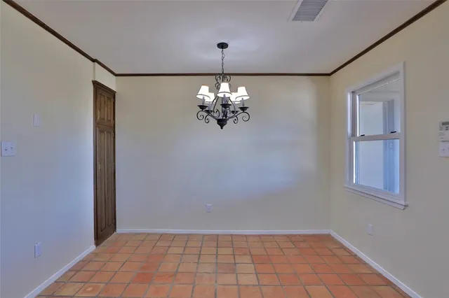 a large kitchen with stainless steel appliances granite countertop a refrigerator and a stove