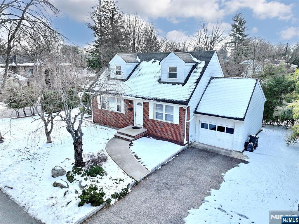 31 Madison Avenue Demarest, NJ 07627 - Photo 1 of 50 a view of a house with a yard covered in snow