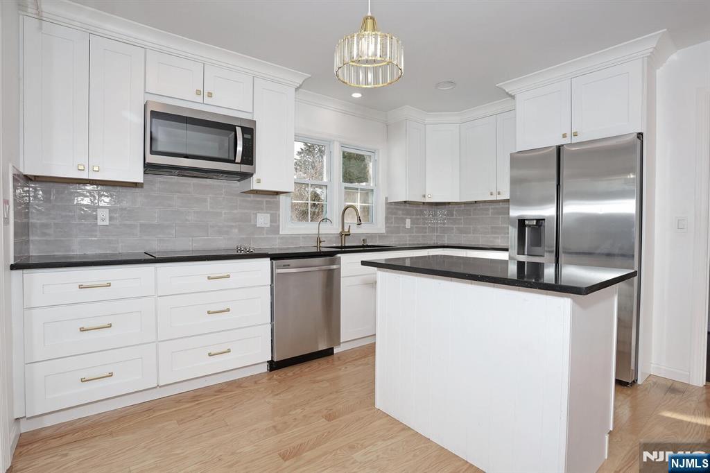 31 Madison Avenue Demarest, NJ 07627 - Photo 12 of 50 a kitchen with granite countertop white cabinets white stainless steel appliances and a counter space