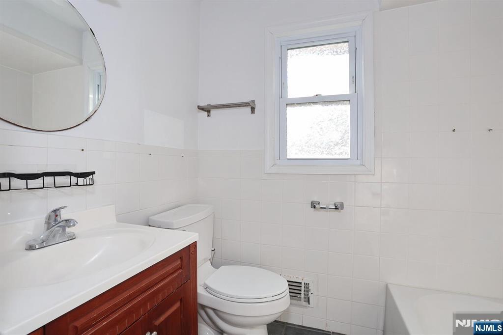 31 Madison Avenue Demarest, NJ 07627 - Photo 14 of 29 a bathroom with a sink a toilet and a mirror