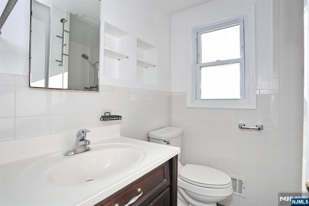 31 Madison Avenue Demarest, NJ 07627 - Photo 20 of 29 a bathroom with a sink toilet a mirror and shower