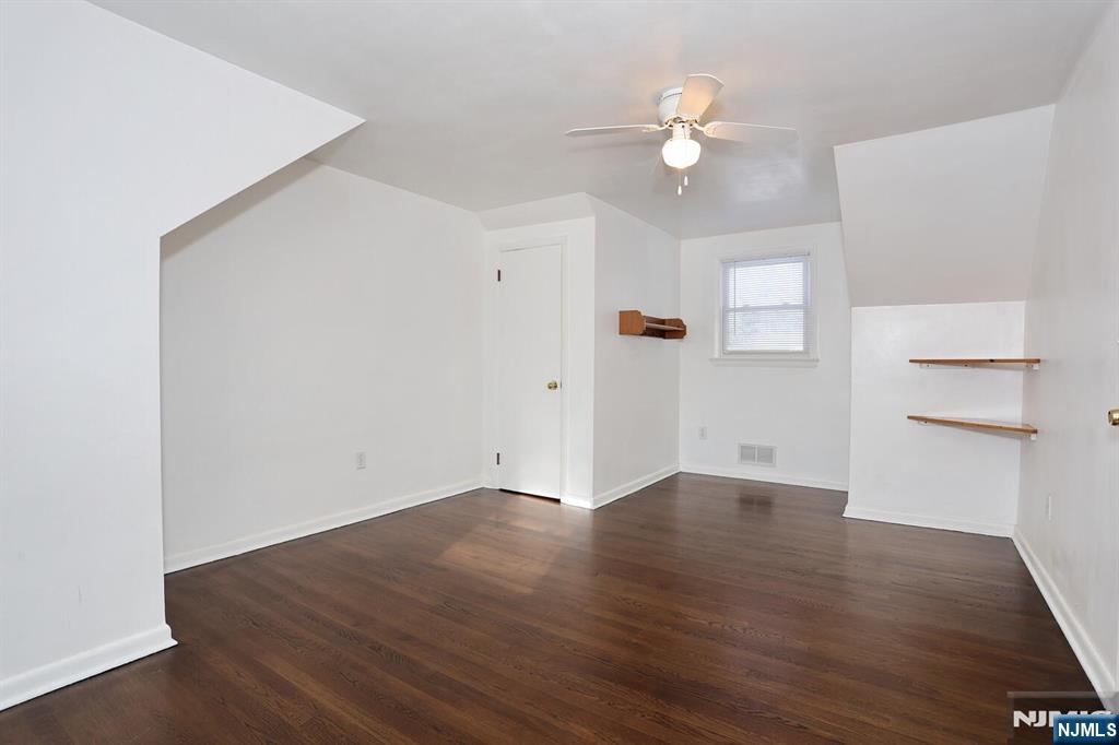 31 Madison Avenue Demarest, NJ 07627 - Photo 26 of 50 an empty room with wooden floor and a ceiling fan