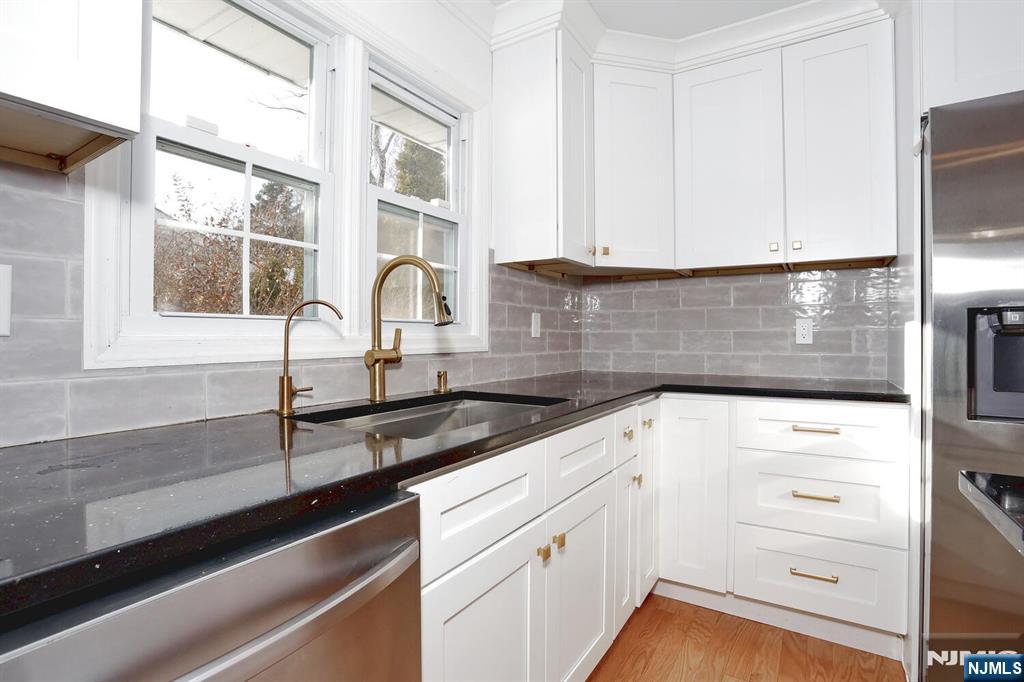 31 Madison Avenue Demarest, NJ 07627 - Photo 9 of 29 a kitchen with white cabinets and a sink